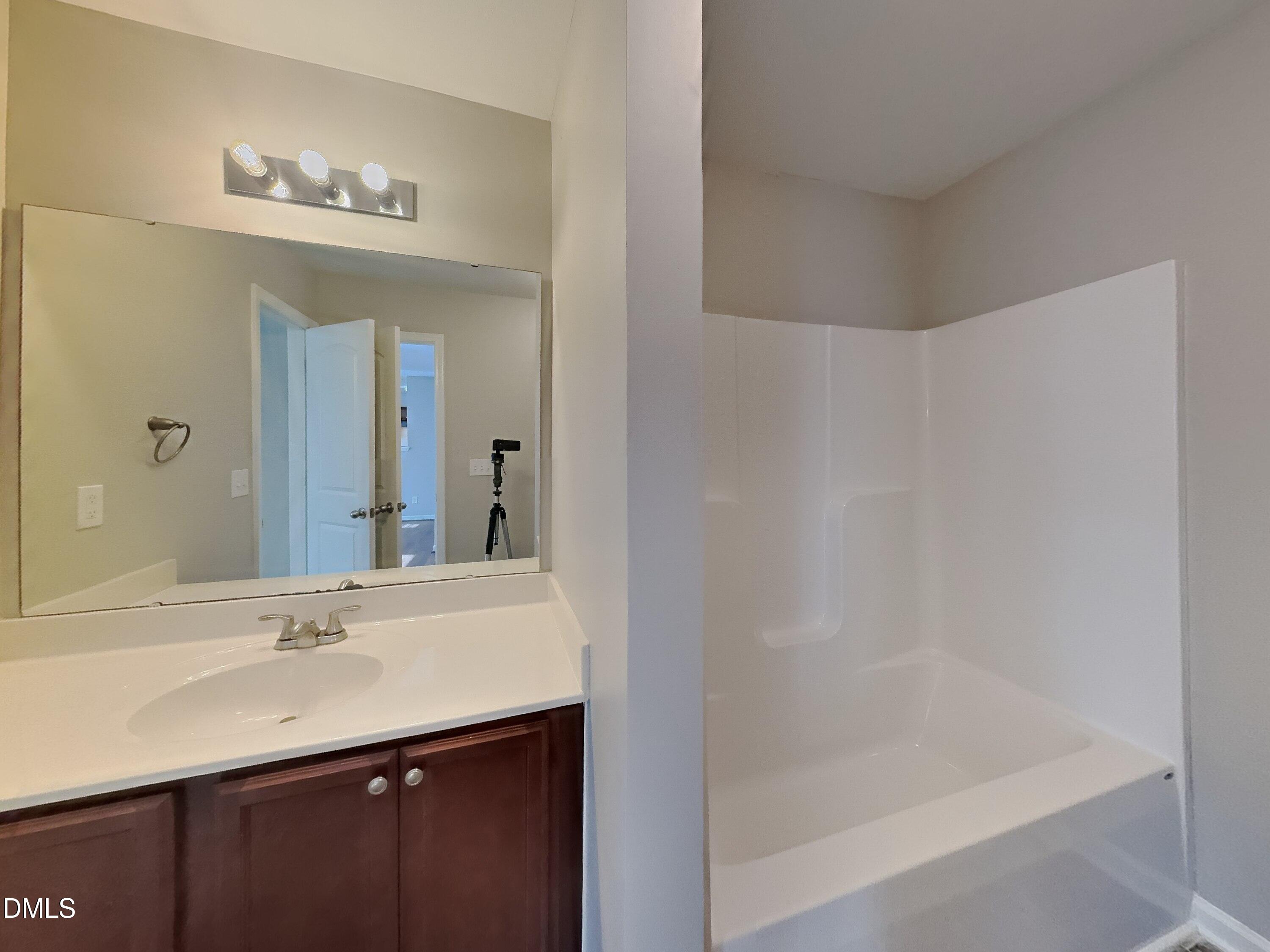30 Gold Rush Court Clayton, NC 27527 - Photo 15 of 20 a bathroom with a bathtub a sink and a mirror
