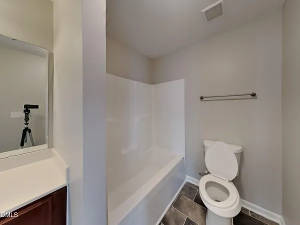 a white toilet sitting next to a bathroom sink