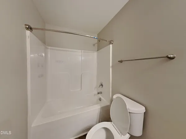a bathroom with a toilet bathtub and shower