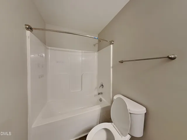 a bathroom with a toilet bathtub and shower