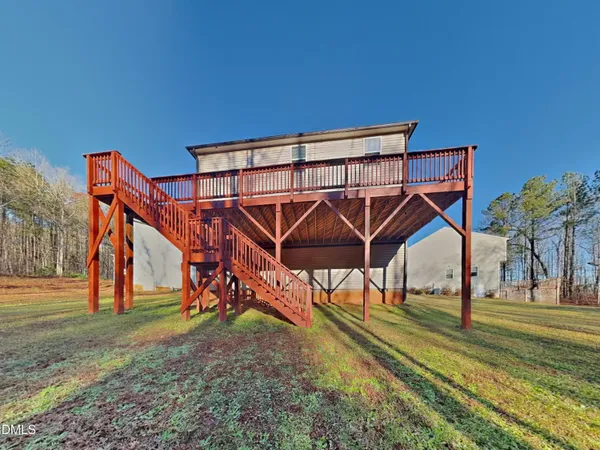a view of a yard with wooden deck