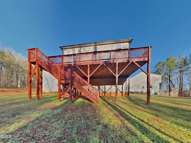 a view of a yard with wooden deck