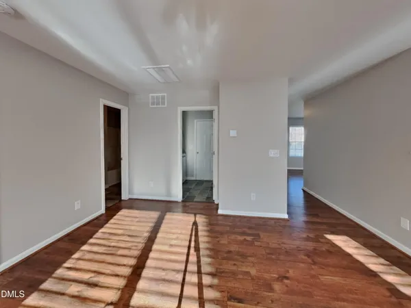 a view of a room with wooden floor