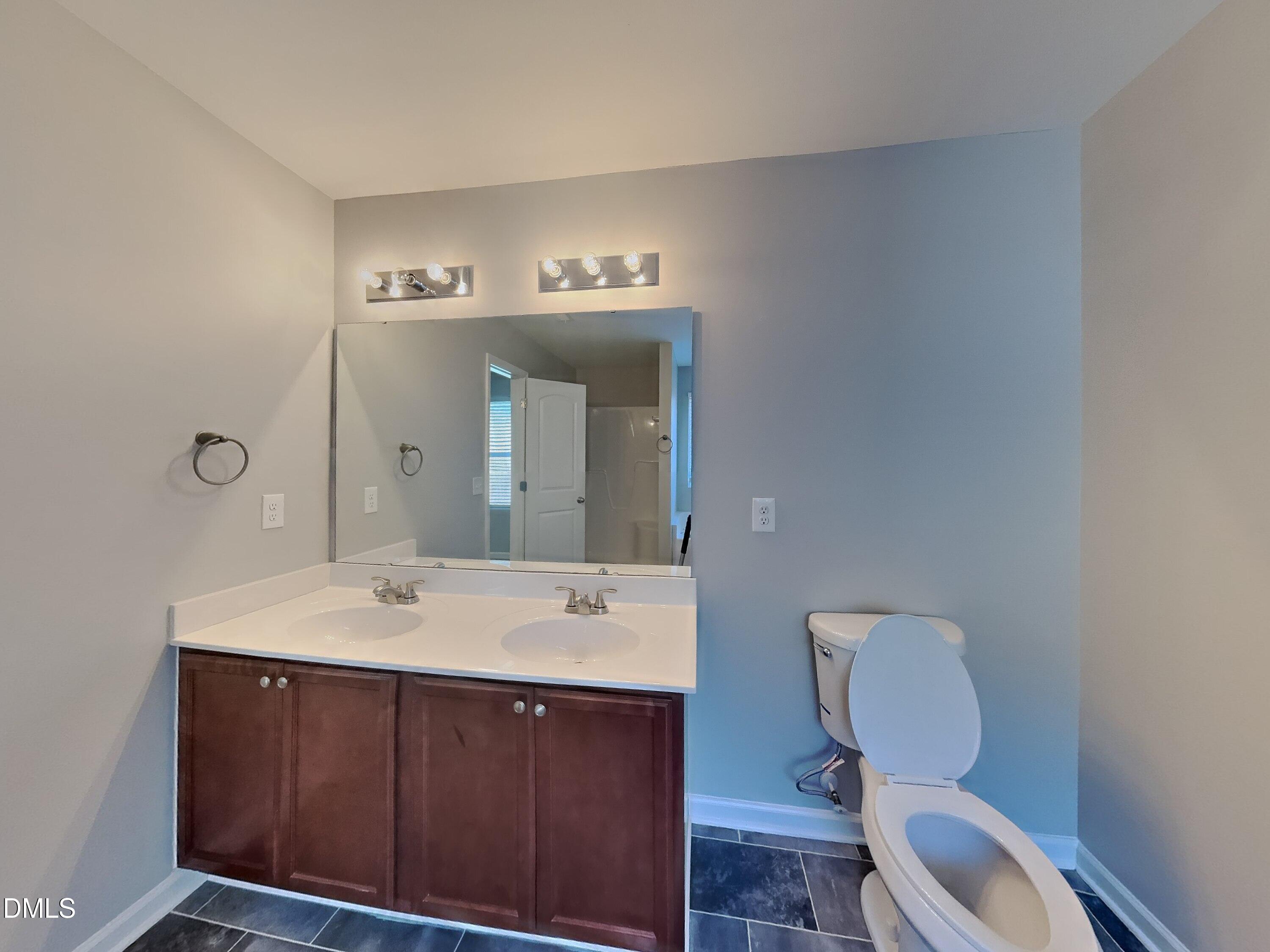 30 Gold Rush Court Clayton, NC 27527 - Photo 9 of 20 a bathroom with a toilet sink and mirror
