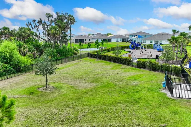 a view of yard with swimming pool and green space