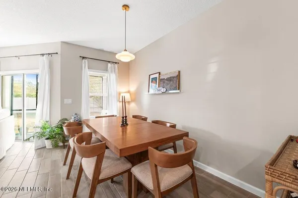 a dining room with furniture and window
