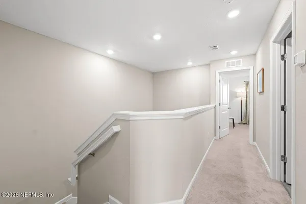 a view of a hallway with white walls