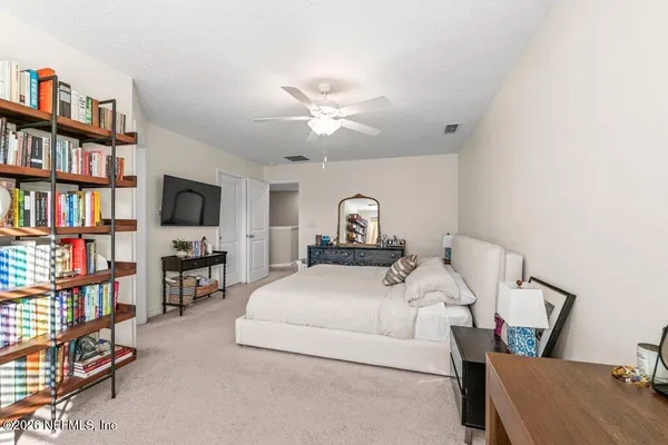 a bedroom with a bed furniture and a book shelf