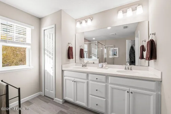 a bathroom with a double vanity sink and a mirror