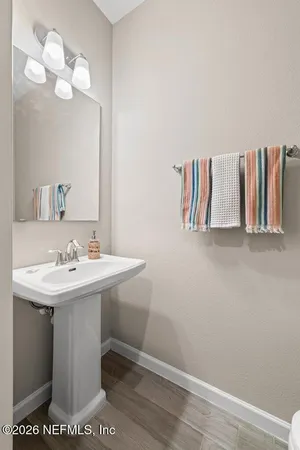 a bathroom with a sink a mirror and vanity