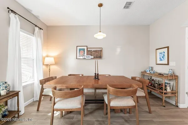 a dining room with furniture and window