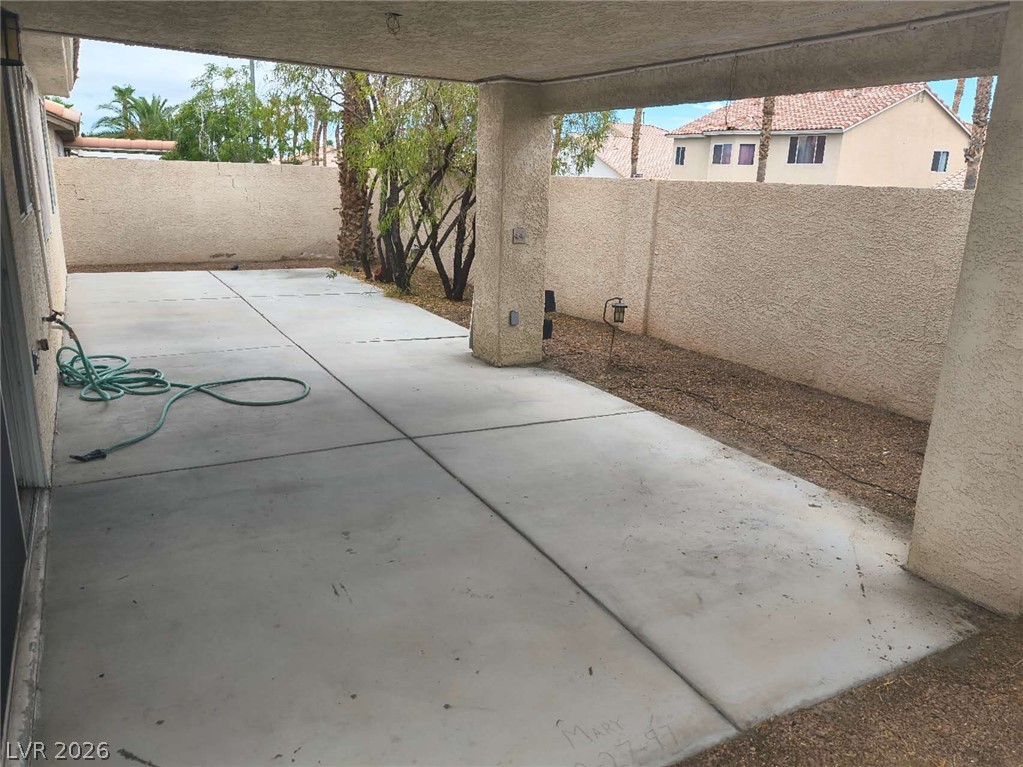 9725 Pima Point Avenue Las Vegas, NV 89147 - Photo 32 of 35 Concrete patio and surrounding xeriscape offer a low-maintenance outdoor living space.