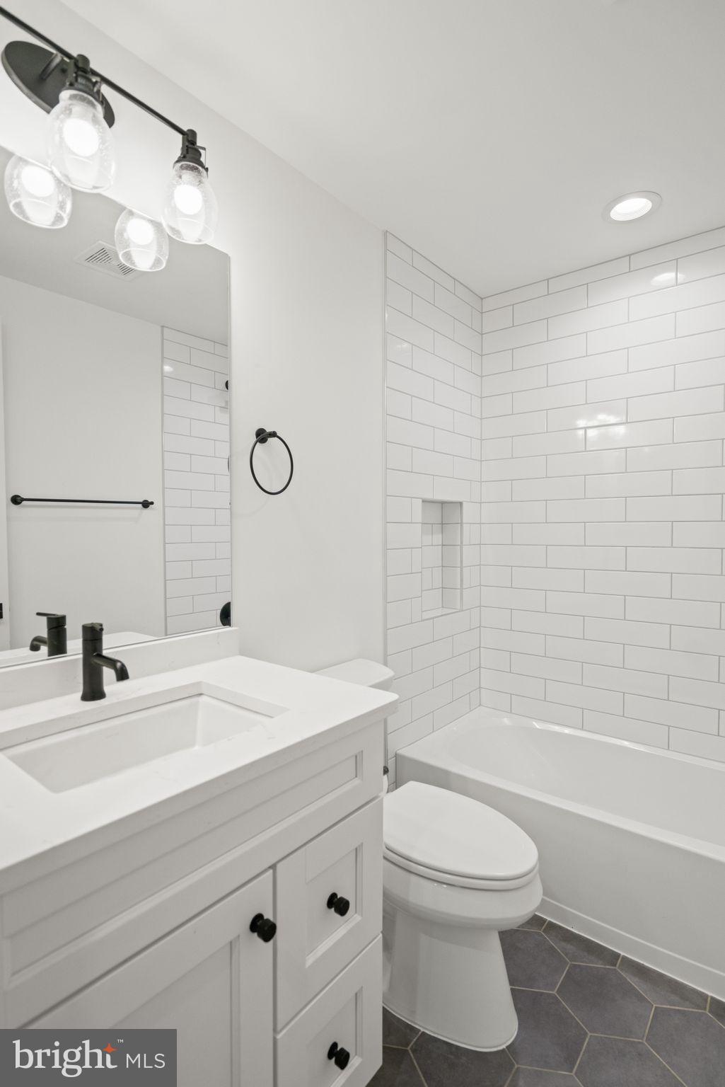 4529 Rosedale Avenue Bethesda, MD 20814 - Photo 111 of 123 a bathroom with a sink a toilet and shower