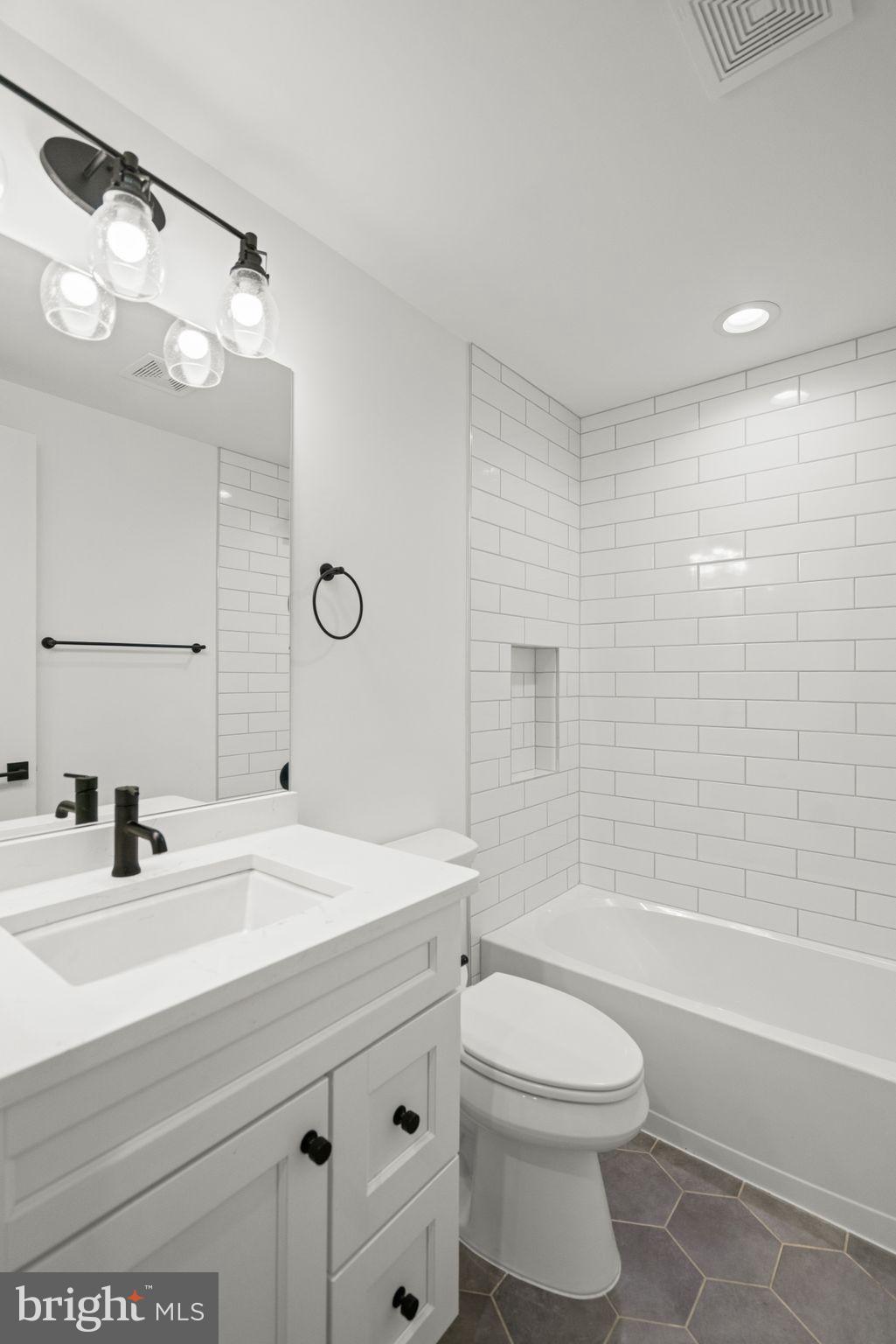 4529 Rosedale Avenue Bethesda, MD 20814 - Photo 112 of 123 a bathroom with a sink a toilet and shower
