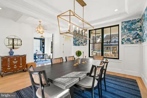 a living room with furniture a large window and chandelier