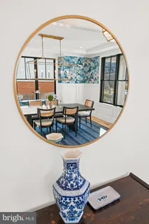 a living room with furniture kitchen view and a wooden floor