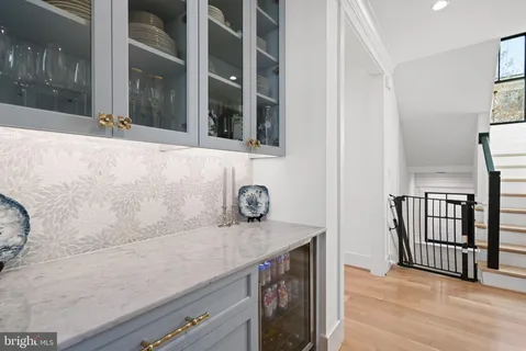 a kitchen with stainless steel appliances kitchen island granite countertop a stove a sink a dining table and chairs with wooden floor