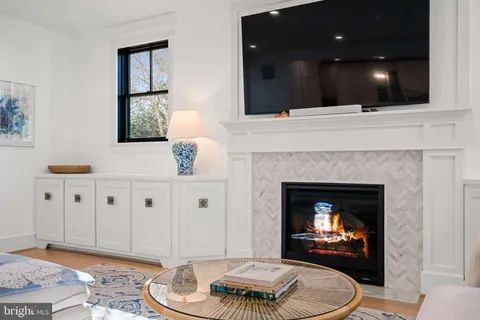 a bedroom with furniture and a large window