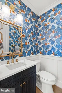 a living room with a bed and a flat screen tv