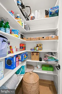 a view of an empty room with wooden floor and closet
