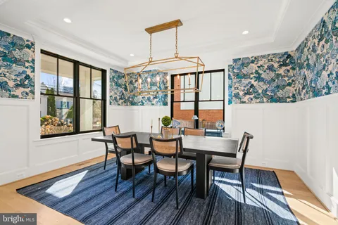 a view of a hallway with wooden floor and entryway