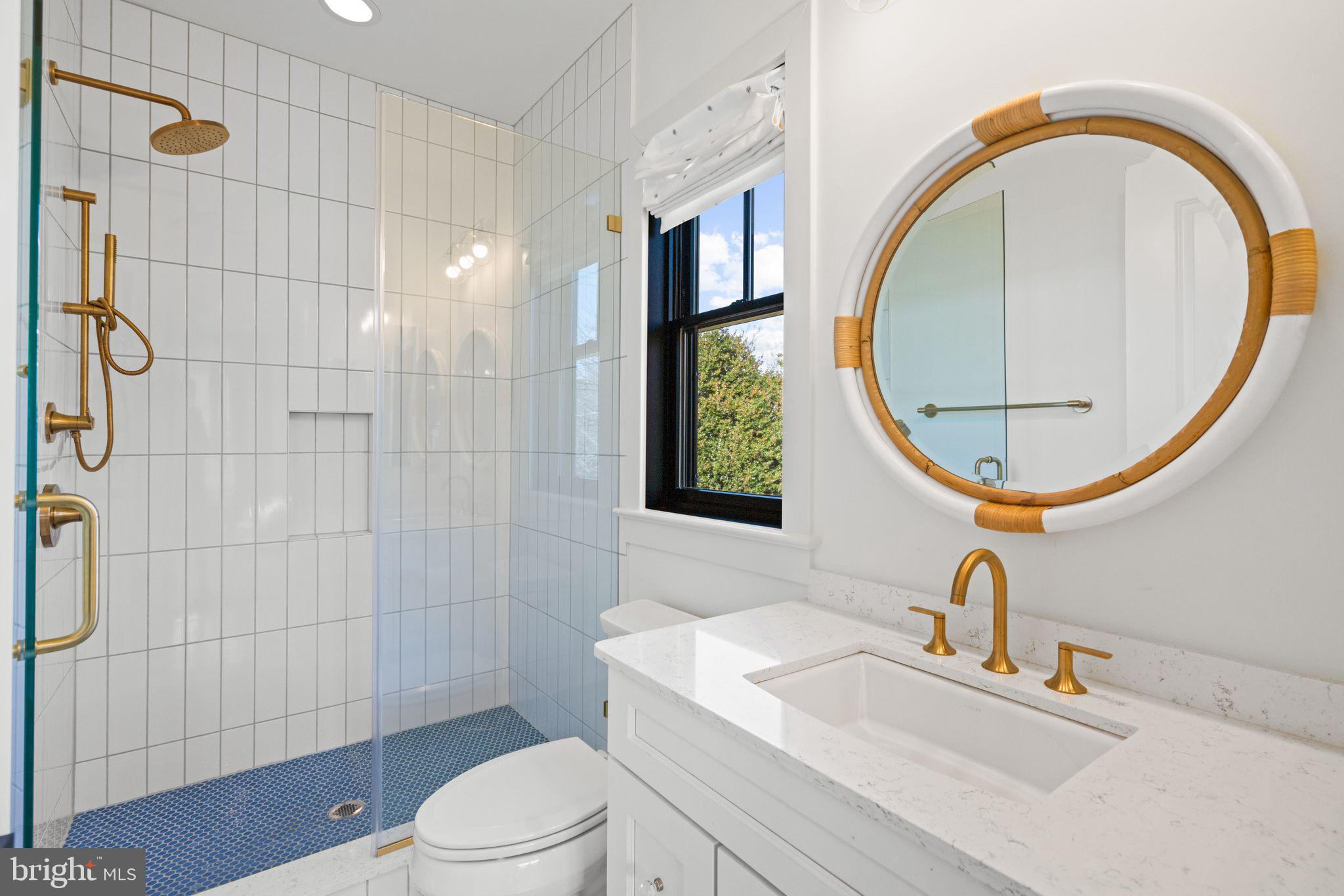 4529 Rosedale Avenue Bethesda, MD 20814 - Photo 76 of 123 a bathroom with a sink a toilet and a mirror