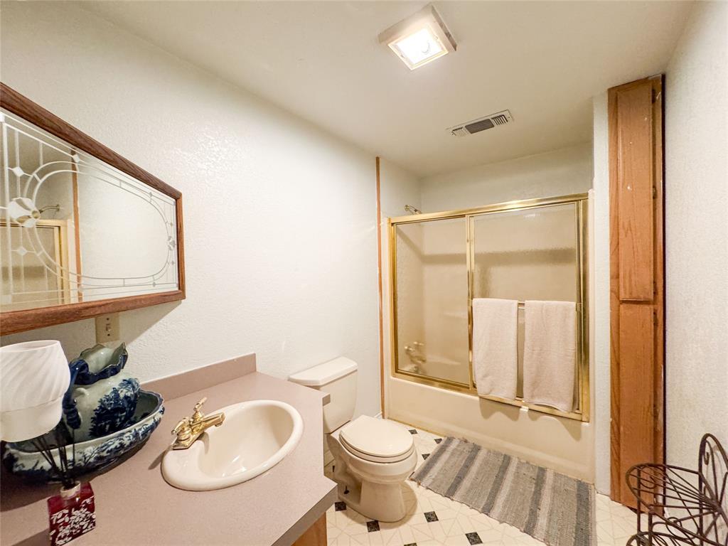 801 Highway 2214 Ranger, TX 76470 - Photo 12 of 40 a bathroom with a toilet a sink and a mirror