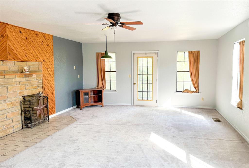801 Highway 2214 Ranger, TX 76470 - Photo 20 of 40 a view of an empty room with a fireplace and a window