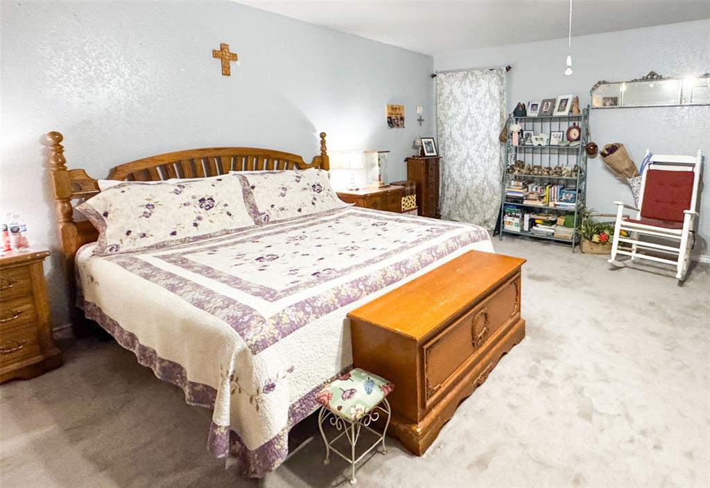 801 Highway 2214 Ranger, TX 76470 - Photo 22 of 40 a bed room with a bed and a chair