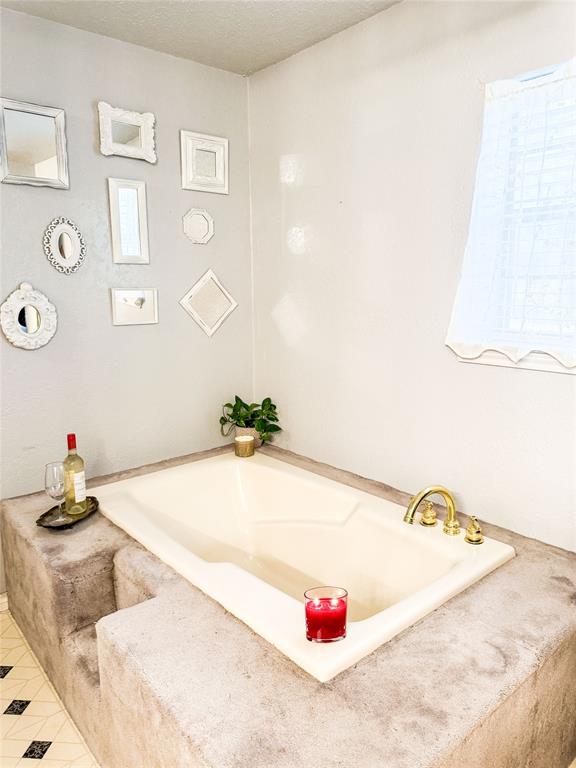 801 Highway 2214 Ranger, TX 76470 - Photo 26 of 40 a bathroom with a tub sink and a chandelier
