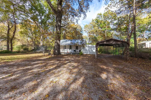 a front view of a house with a yard and shrubs