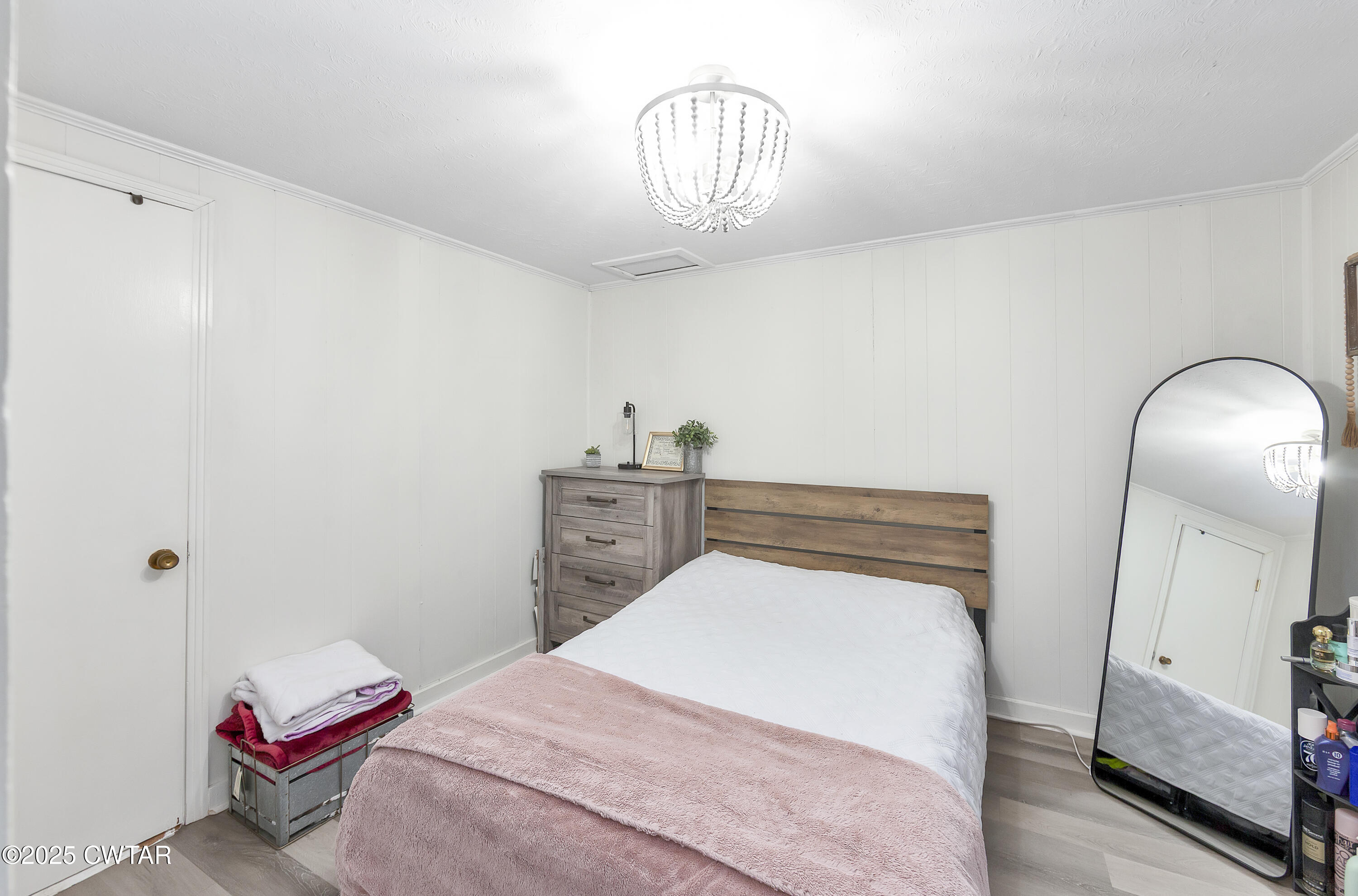 133 Mason Street Gadsden, TN 38337 - Photo 21 of 21 a bedroom with a bed and a chandelier