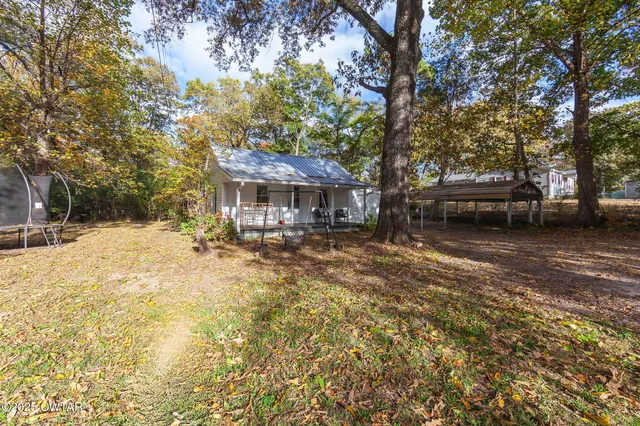 a view of a house with a yard covered in snow