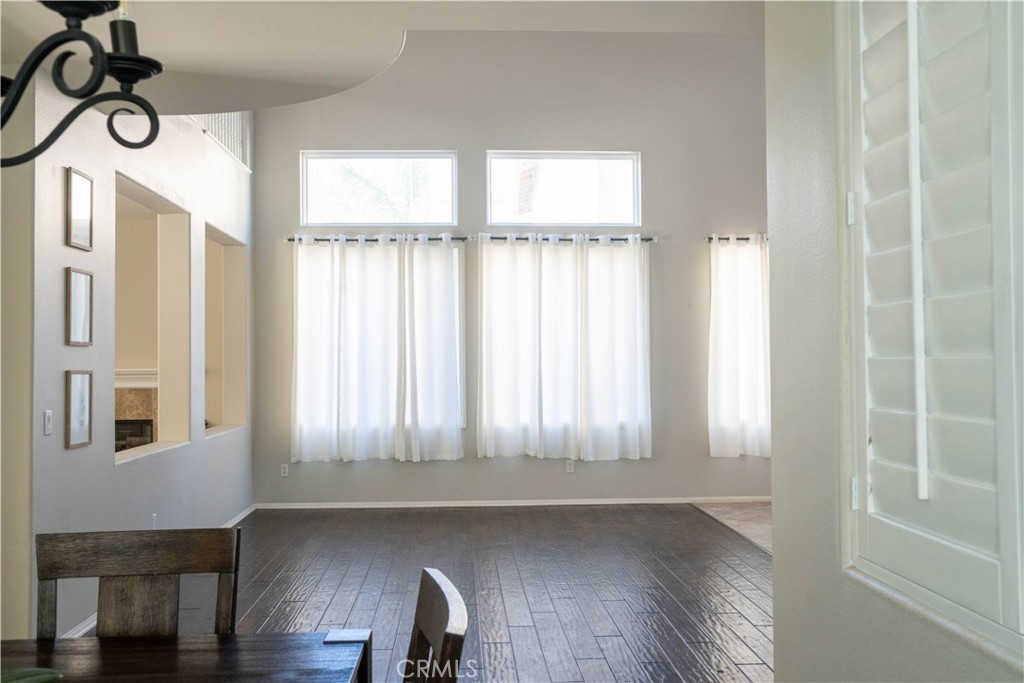 36719 Torrey Pines Drive Beaumont, CA 92223 - Photo 12 of 56 a view of an empty room with wooden floor and a window