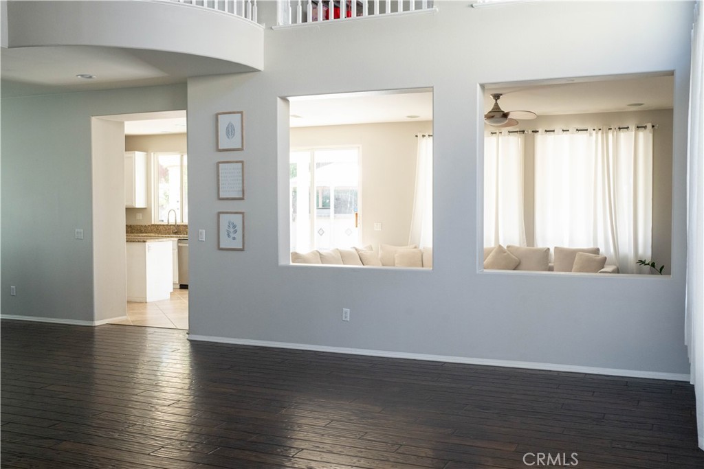36719 Torrey Pines Drive Beaumont, CA 92223 - Photo 13 of 56 a view of an empty room with wooden floor and a window