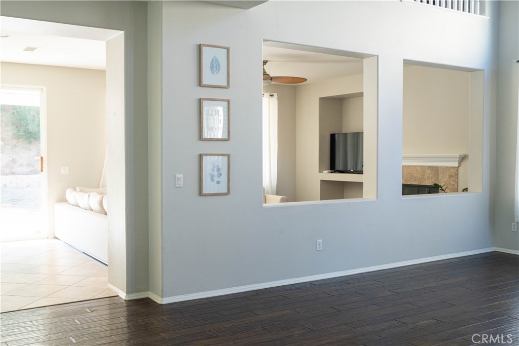 36719 Torrey Pines Drive Beaumont, CA 92223 - Photo 14 of 56 a view of a hallway with wooden floor and a living room
