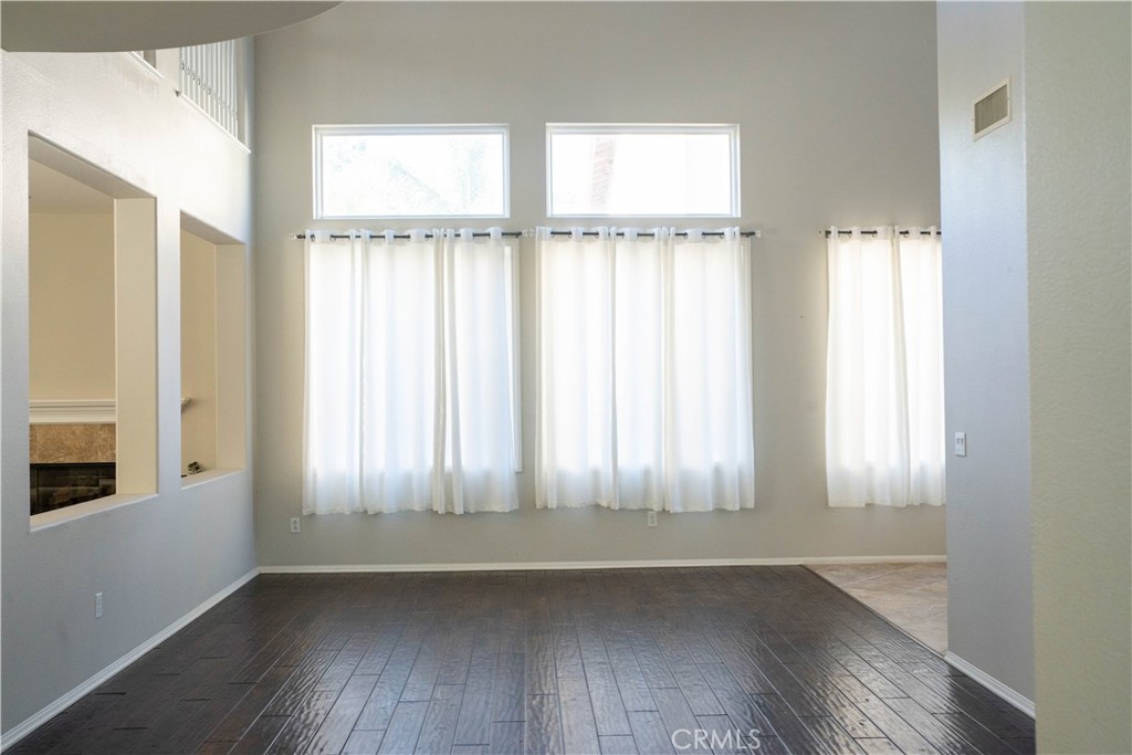 36719 Torrey Pines Drive Beaumont, CA 92223 - Photo 16 of 56 an empty room with wooden floor and windows