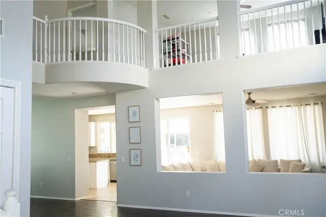 a living room with stainless steel appliances granite countertop a couch a stove a microwave a sink and cabinets
