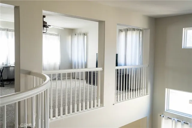a living room with furniture white walls and a window