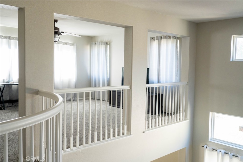 36719 Torrey Pines Drive Beaumont, CA 92223 - Photo 19 of 56 a view of a bedroom with wooden floor and windows