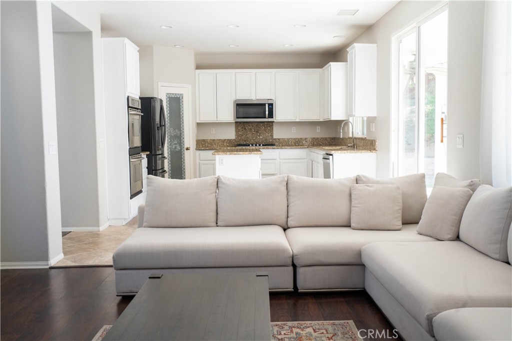 36719 Torrey Pines Drive Beaumont, CA 92223 - Photo 22 of 56 a living room with furniture white walls and a window