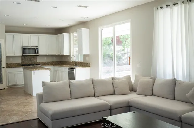 a living room with furniture a fireplace and a window