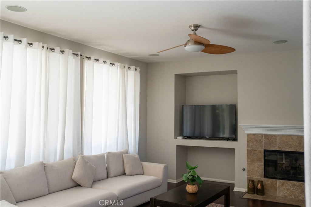 36719 Torrey Pines Drive Beaumont, CA 92223 - Photo 26 of 56 a living room with furniture a fireplace and a window