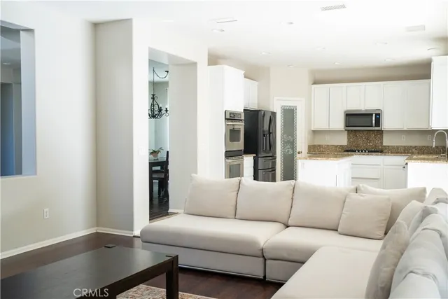 a kitchen with granite countertop a sink a stove and microwave