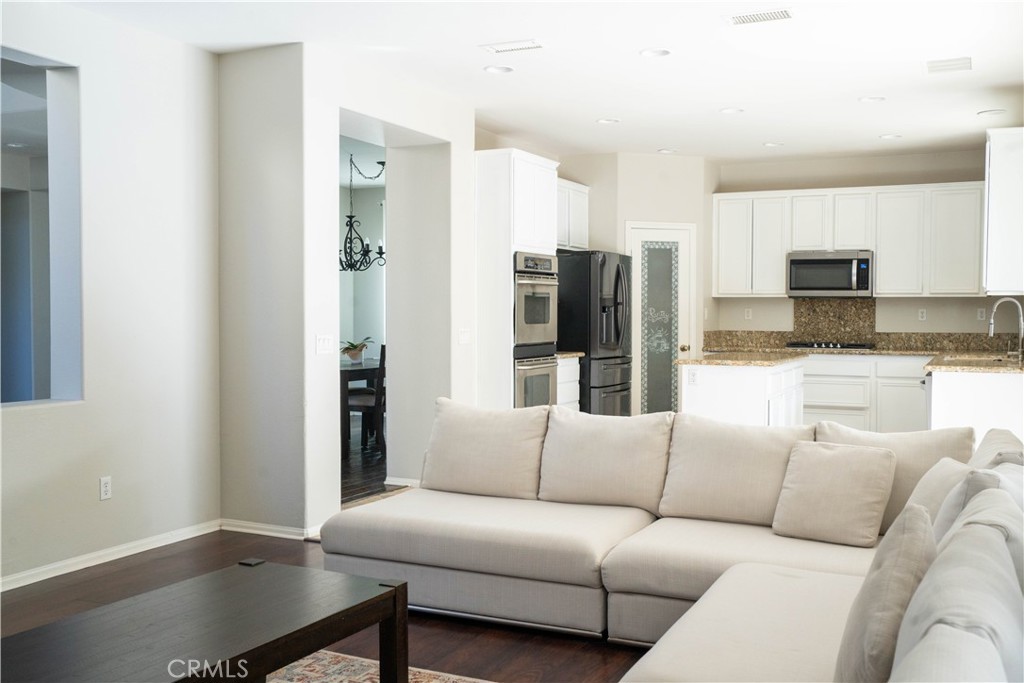 36719 Torrey Pines Drive Beaumont, CA 92223 - Photo 27 of 56 a living room with stainless steel appliances kitchen island granite countertop a refrigerator a stove and a sink with granite countertops