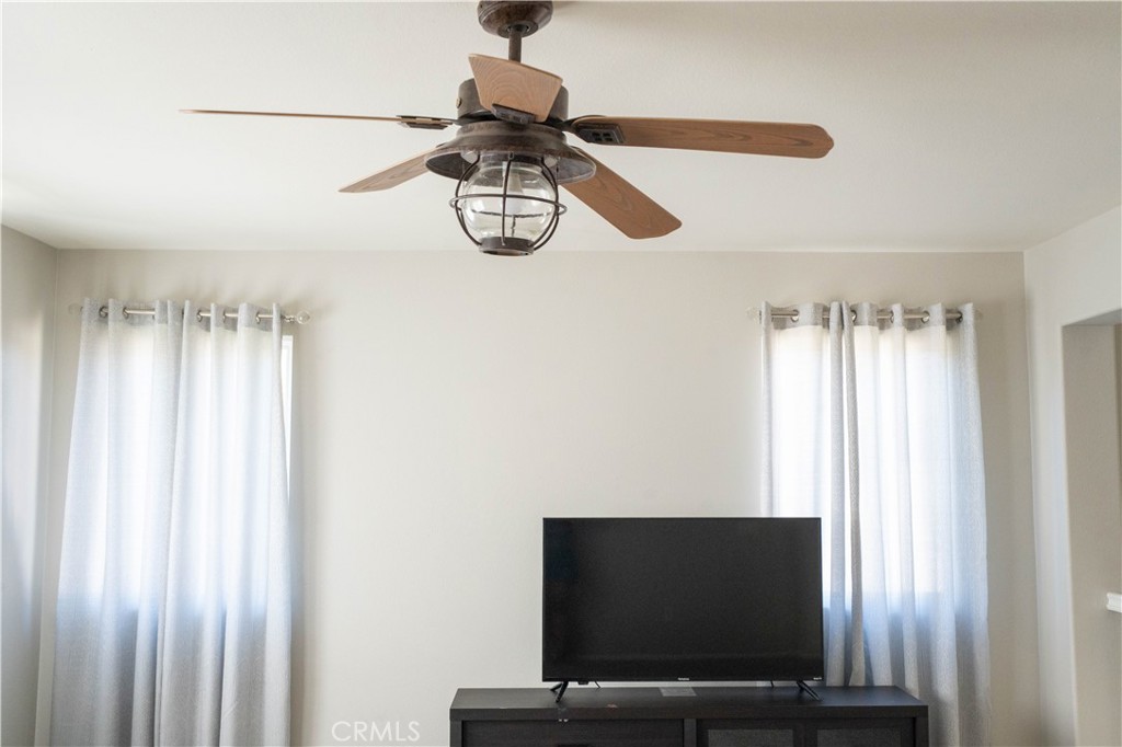 36719 Torrey Pines Drive Beaumont, CA 92223 - Photo 32 of 56 a living room with a flat screen tv and a window