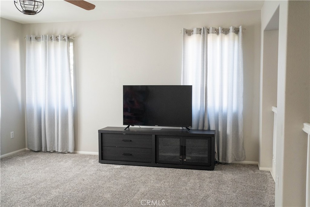 36719 Torrey Pines Drive Beaumont, CA 92223 - Photo 33 of 56 a living room with furniture and a flat screen tv