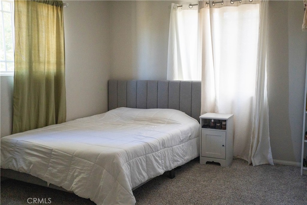 36719 Torrey Pines Drive Beaumont, CA 92223 - Photo 37 of 56 a bedroom with a bed and window