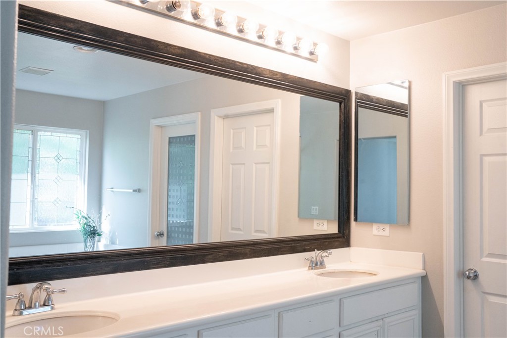 36719 Torrey Pines Drive Beaumont, CA 92223 - Photo 41 of 56 a bathroom with a sink and a mirror