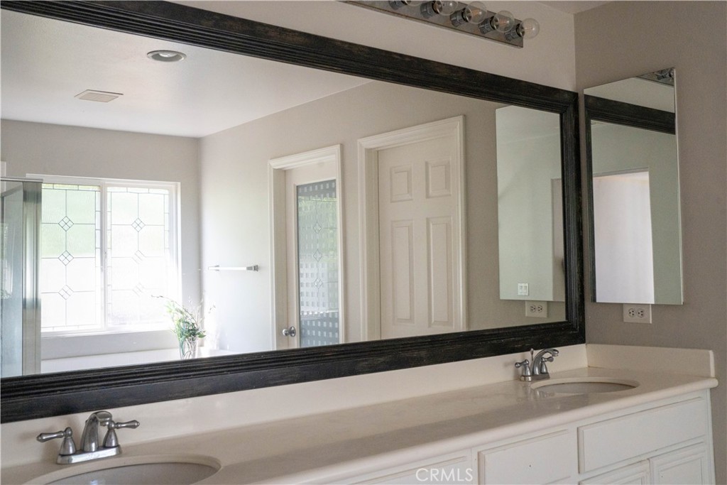 36719 Torrey Pines Drive Beaumont, CA 92223 - Photo 42 of 56 a bathroom with a sink and a mirror